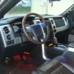 Before and after photographs of a damaged Ford pickup truck that was repaired by Elite Paint & Body Shop in West Palm Beach, Florida.